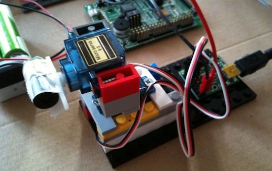 A servo controlling a red laser pointer.